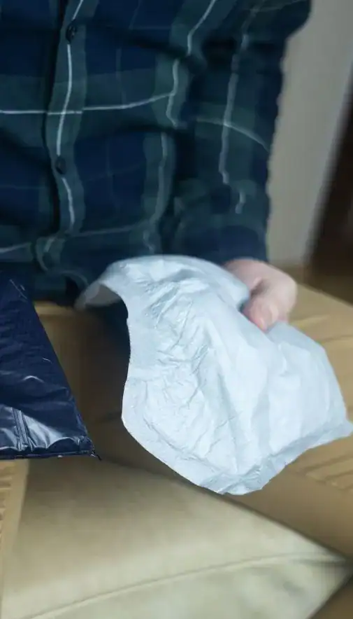 Image of man holding incontinence pads as part of overactive bladder treatment Derby